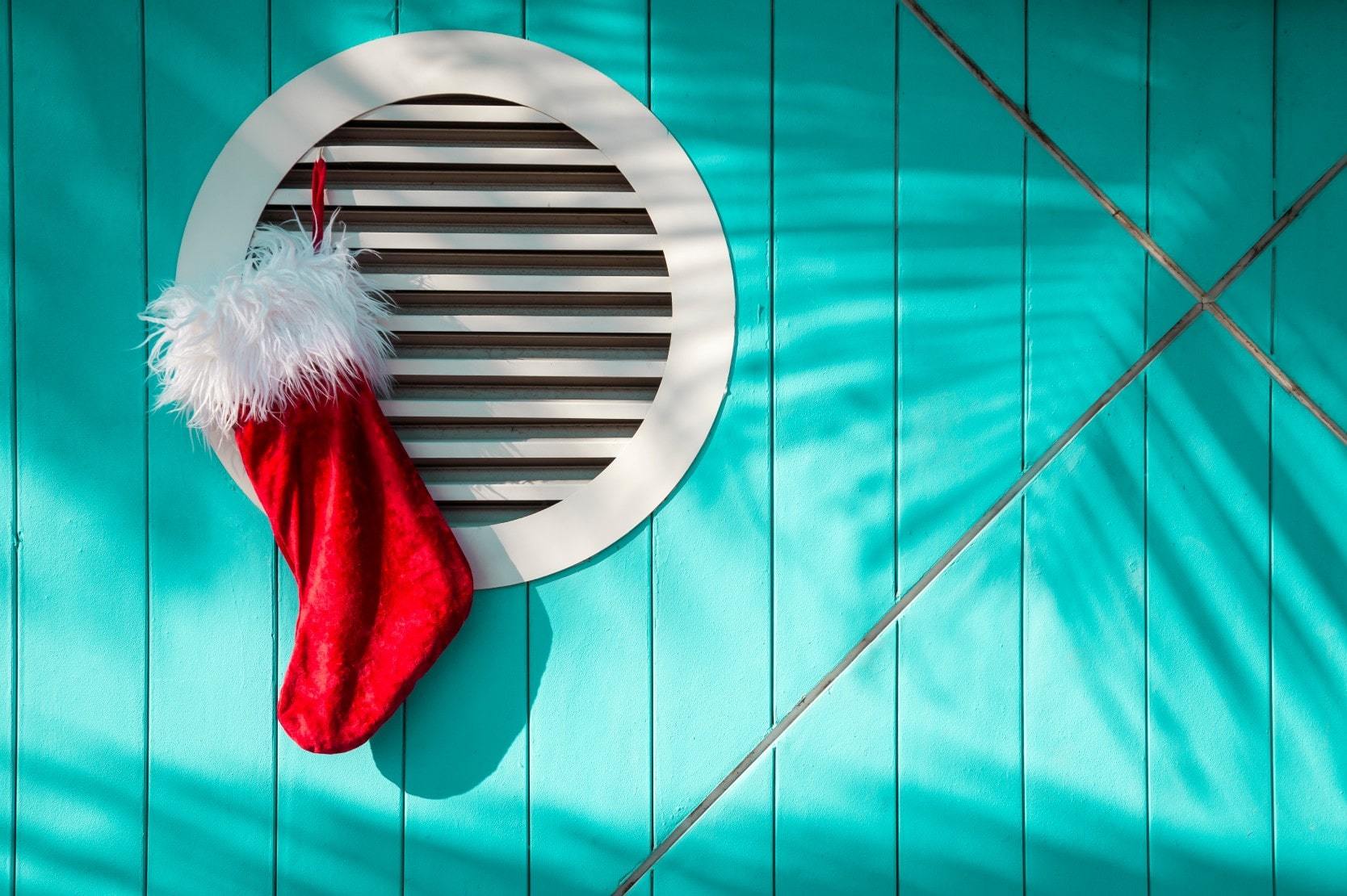 Christmas stocking hanging on a blue beach house in Florida